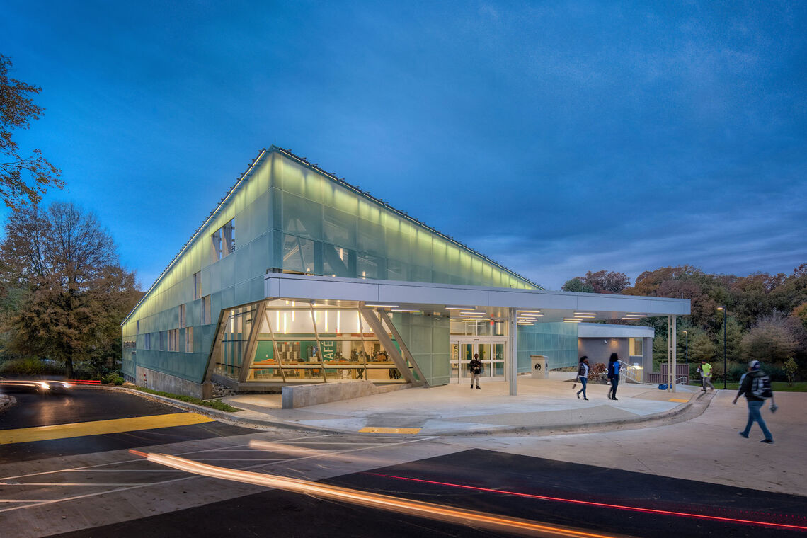 Responding to the dynamic shift of libraries from places of quiet study to vibrant centers of community collaboration, the two-dimensional triangular floor plan transforms into a three-dimensional prism that breaks through New Carrollton Library's former understated entry.