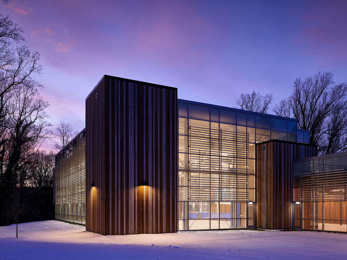 The Cahill Fitness & Wellness Center's natural forms and exterior material palette of wood and glass curtainwall merge the facility with the forested landscape.