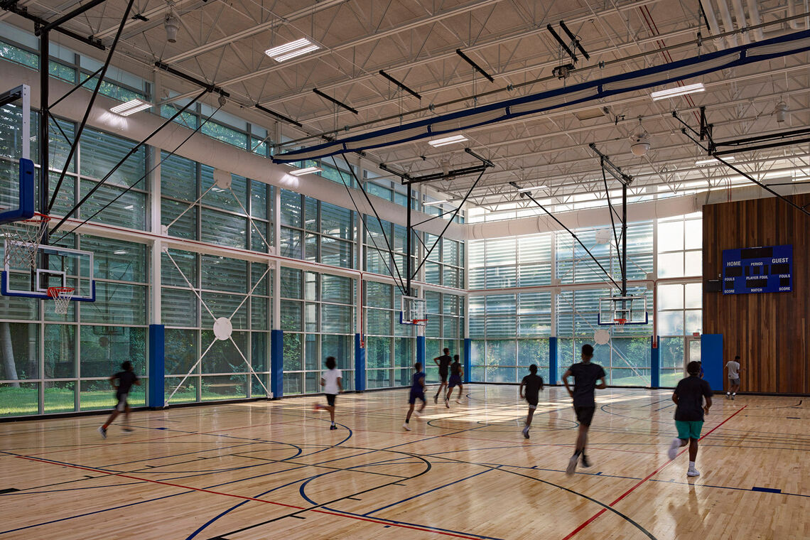 Over 80% of occupied floor areas have direct views to the natural woodland setting, including within program spaces that are traditionally devoid of natural light like the gymnasium, natatorium, and fitness areas.